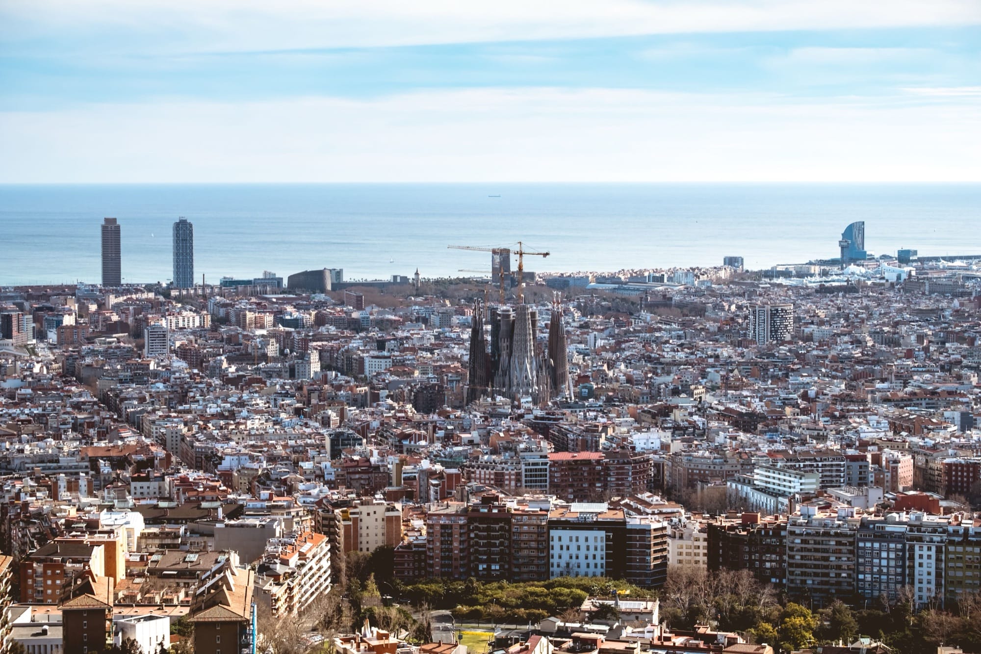 Aerial view of the Barcelona skyline with the Sagrada Familia and the sea