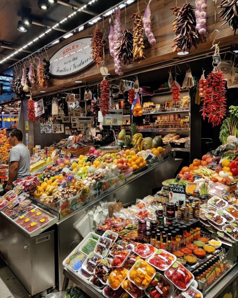 Fresh fruit and juice stalls at La Boqueria market in Barcelona