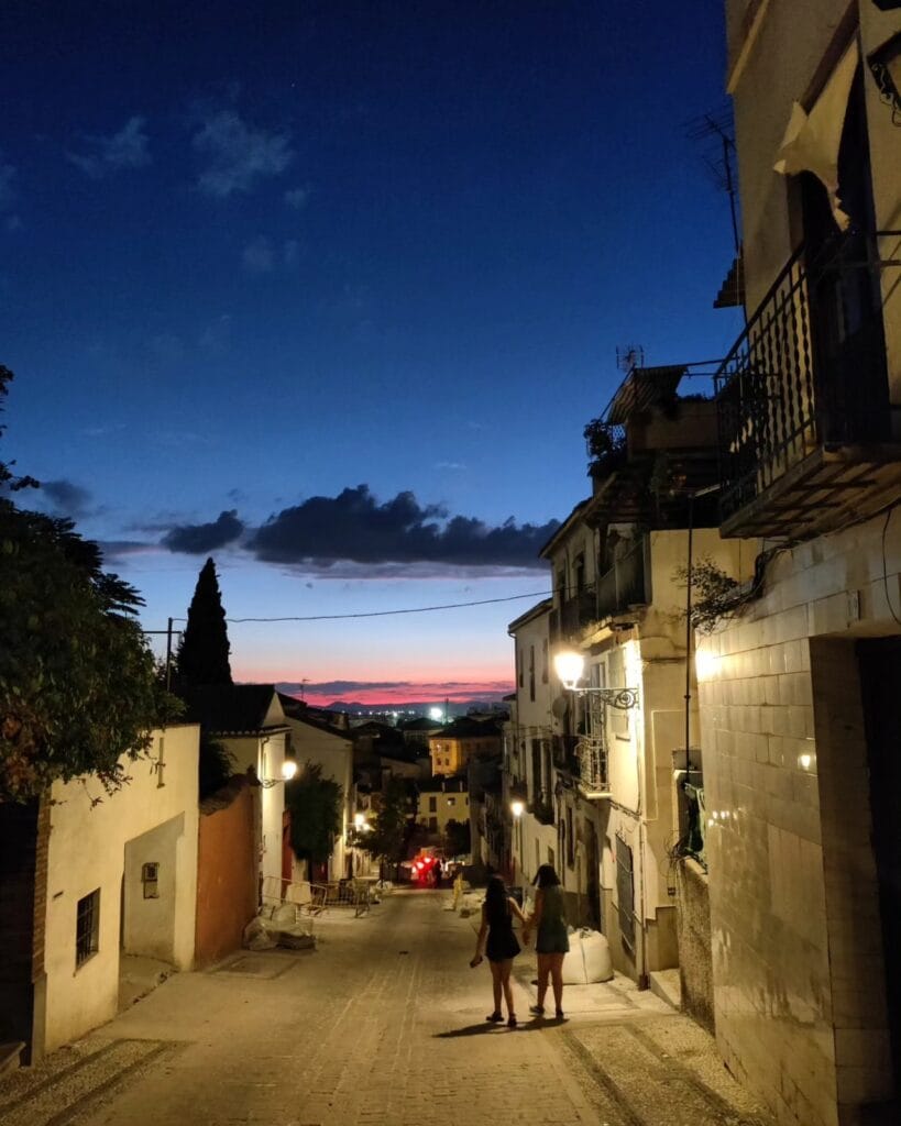 Albaicin lane at blue hour with a pink sunset stripe, Granada