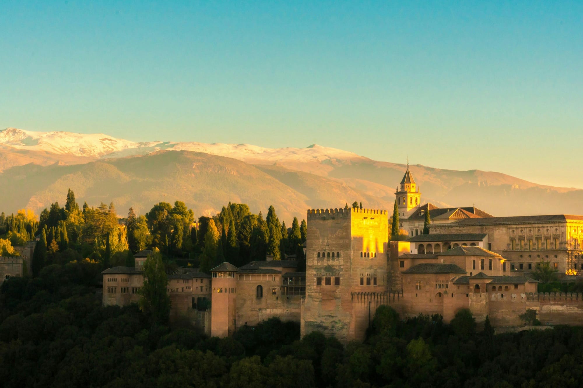 The Alhambra glowing at sunset above Granada