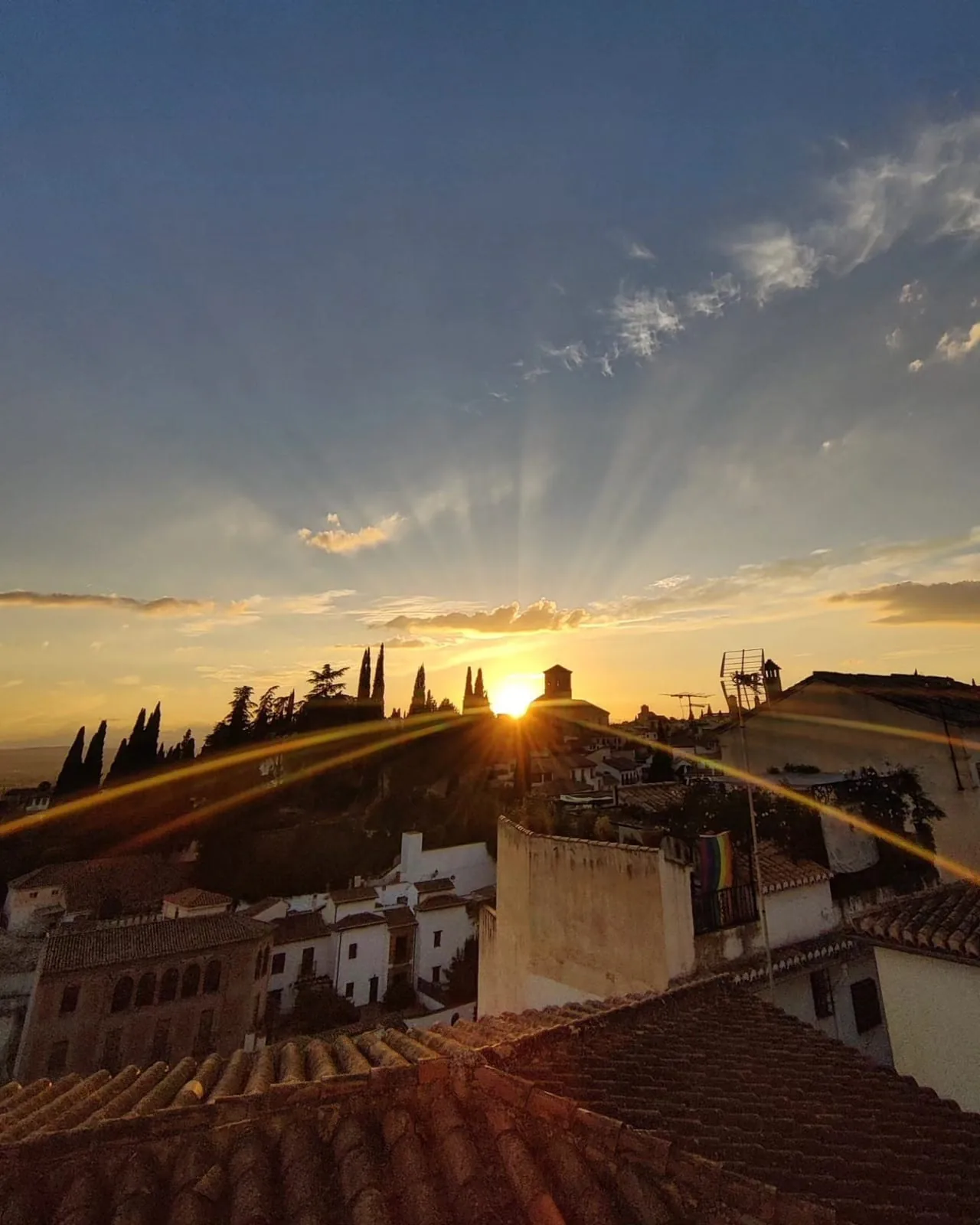 Sunburst sunset over the rooftops of the Albaicin in Granada
