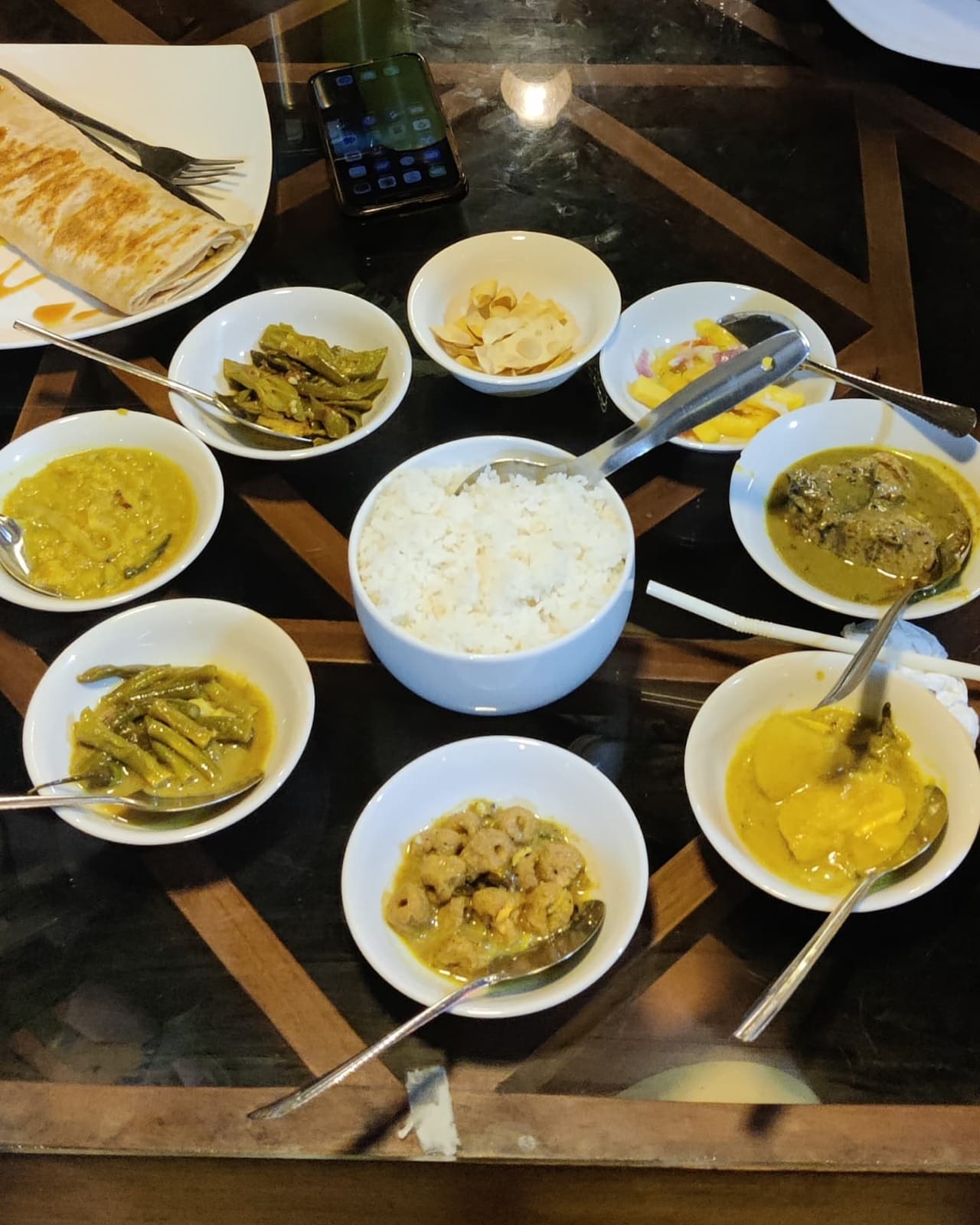 Classic Sri Lankan rice and curry spread with small curry bowls and papadum