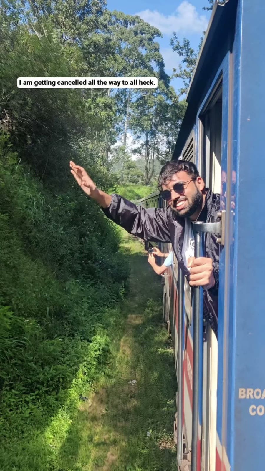 Hanging out of the open train door at altitude, story frame captioned getting cancelled all the way to heck