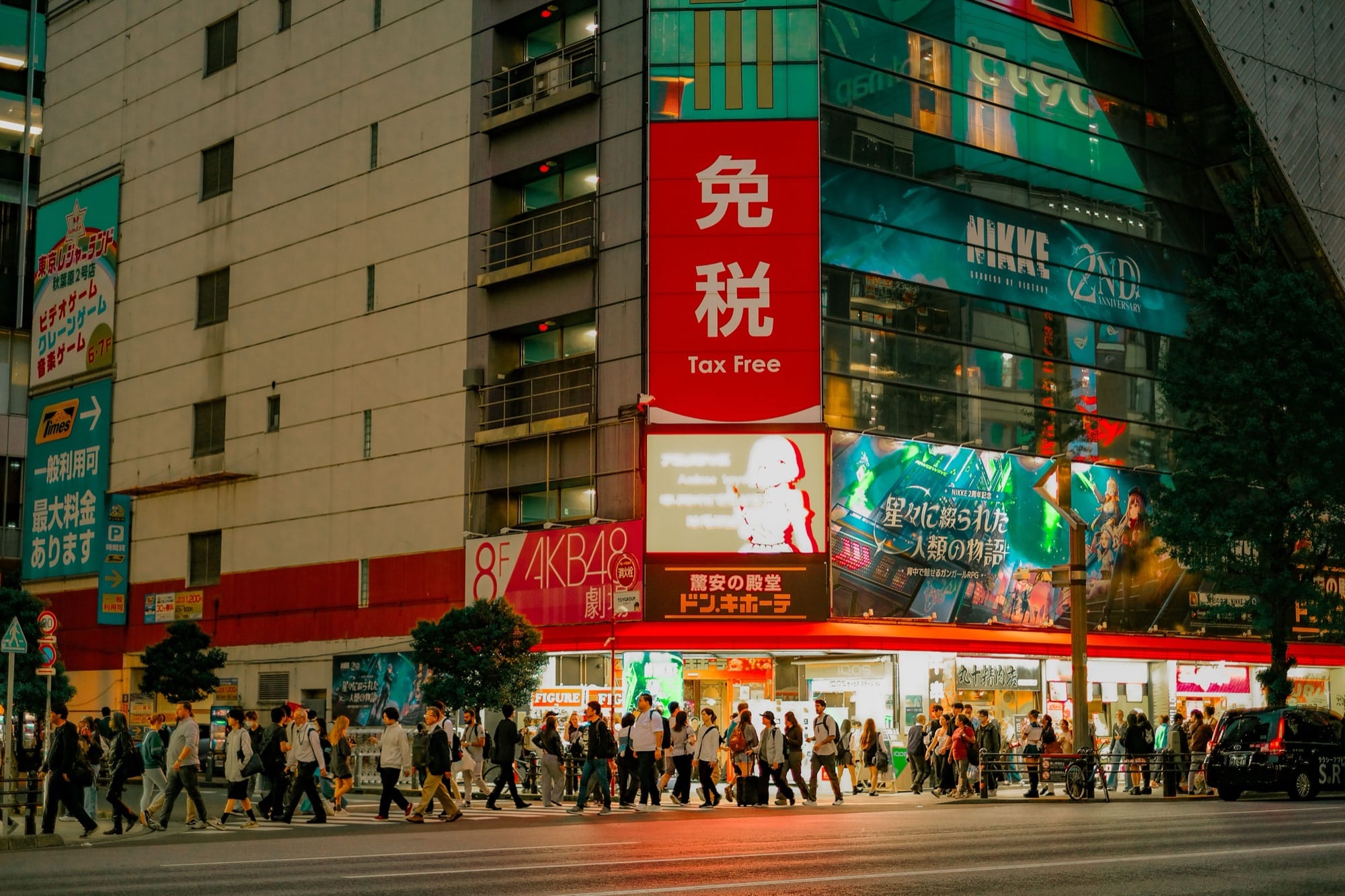 Neon-lit anime billboards and electronics stores along Chuo-dori in Akihabara Electric Town, Tokyo, at night