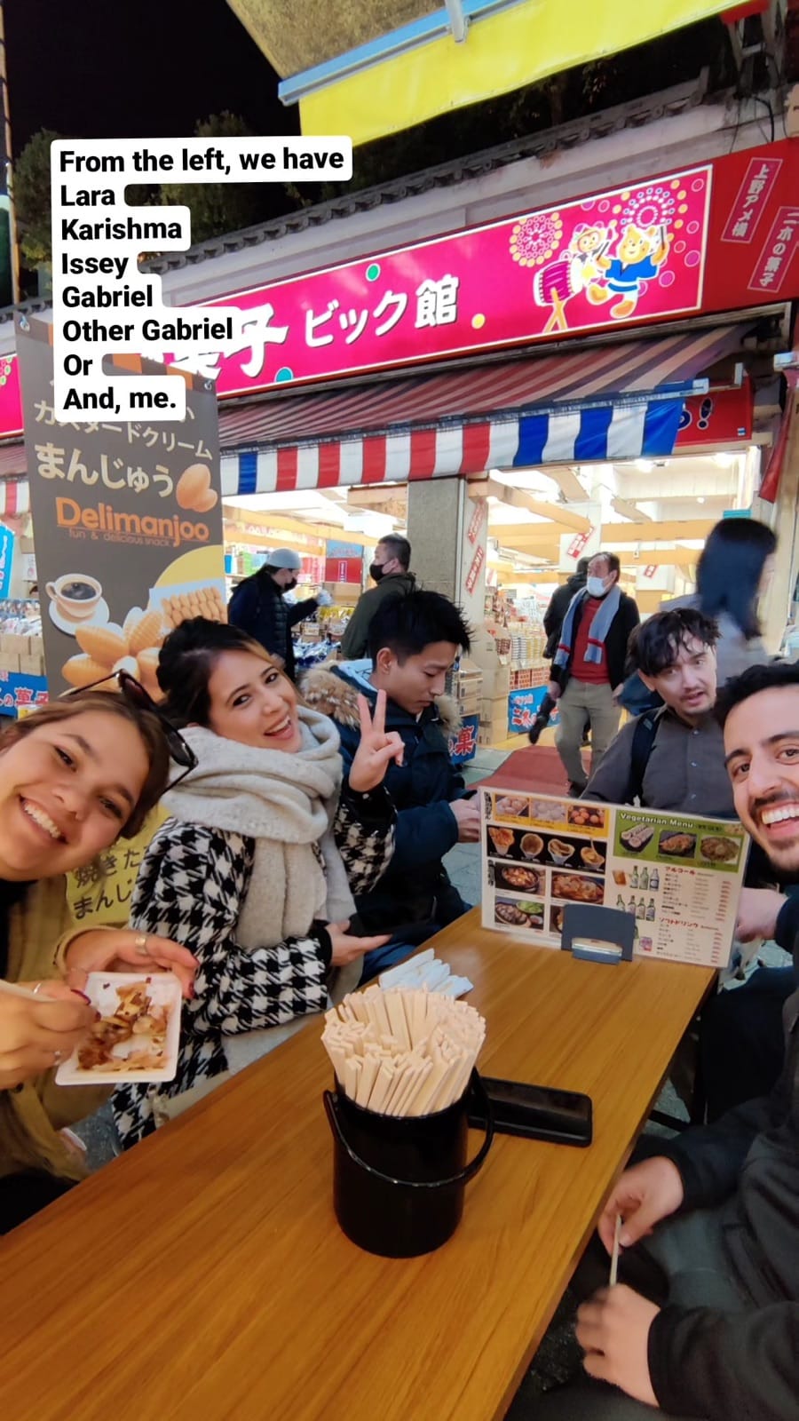 Group selfie at restaurant with team from walking tour.