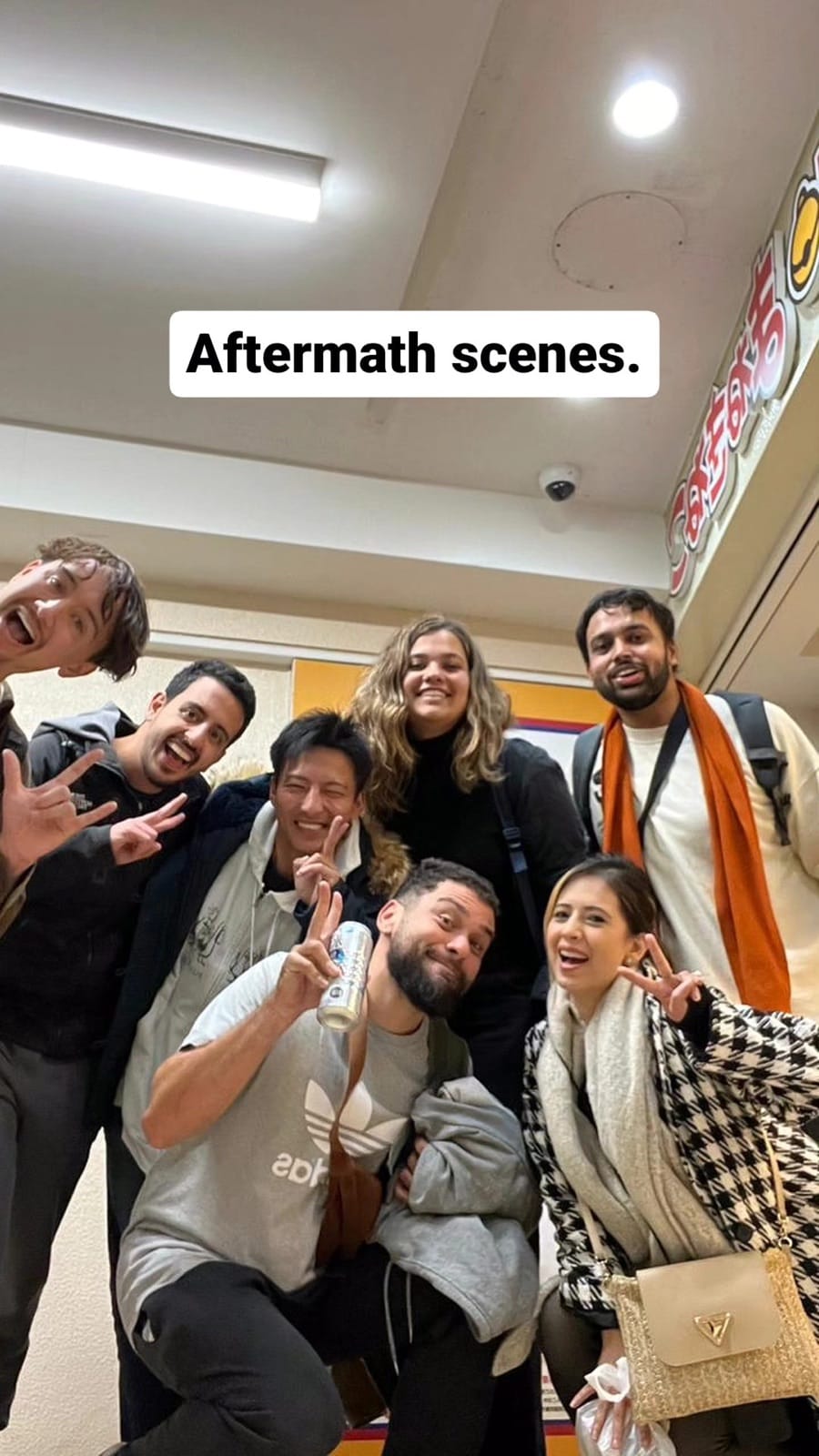 Group photo in karaoke room hallway.