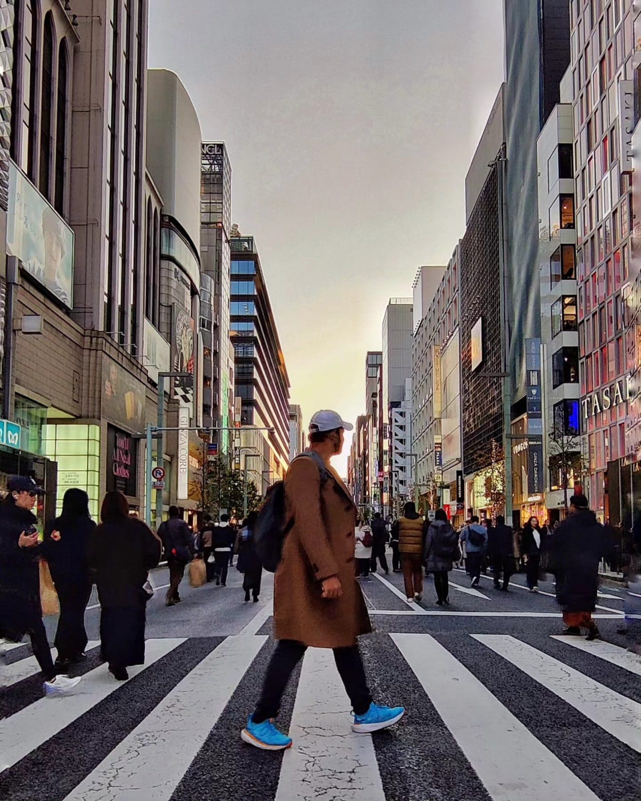 The author crossing Chuo-dori in Ginza at sunset in a long brown coat