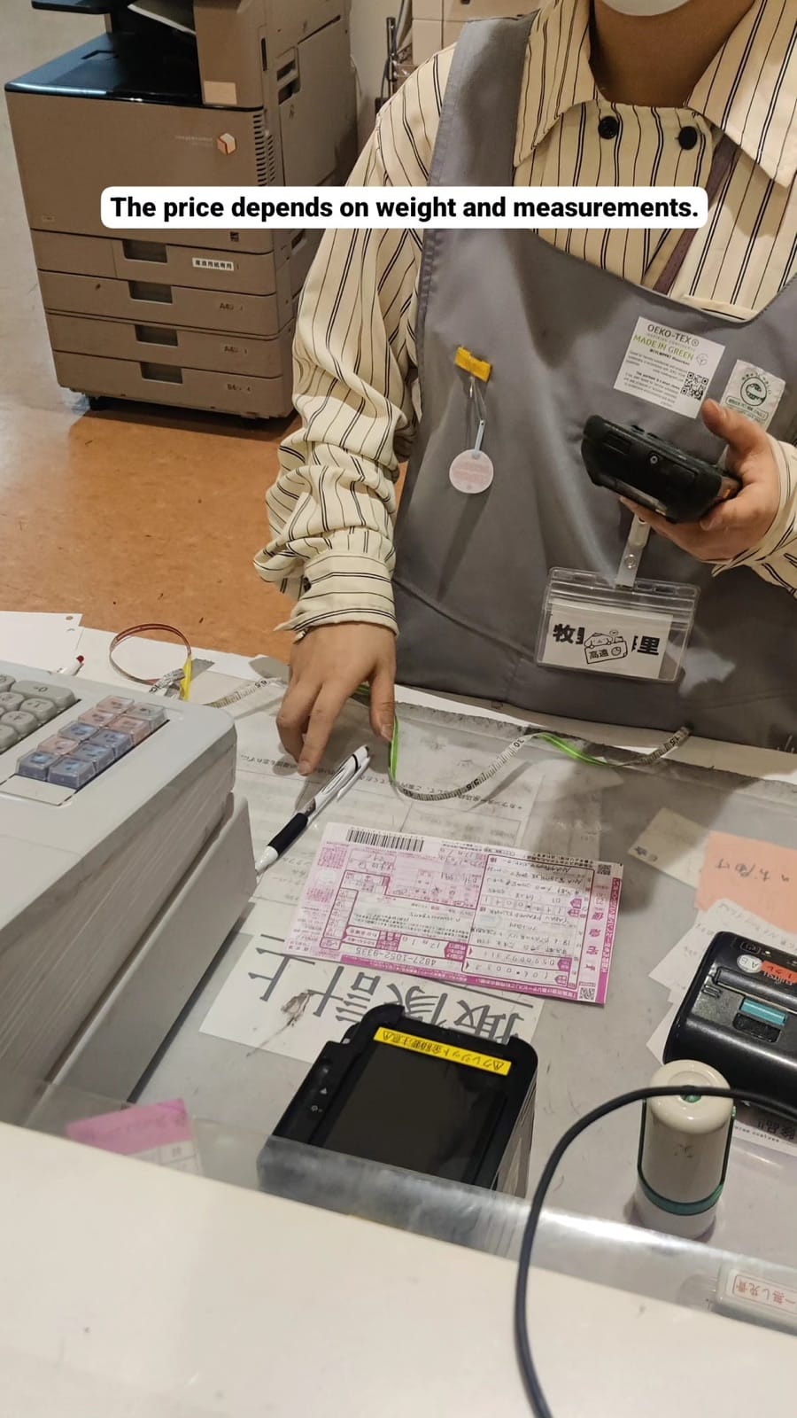 A Yamato Transport clerk processing a luggage shipping form in Tokyo