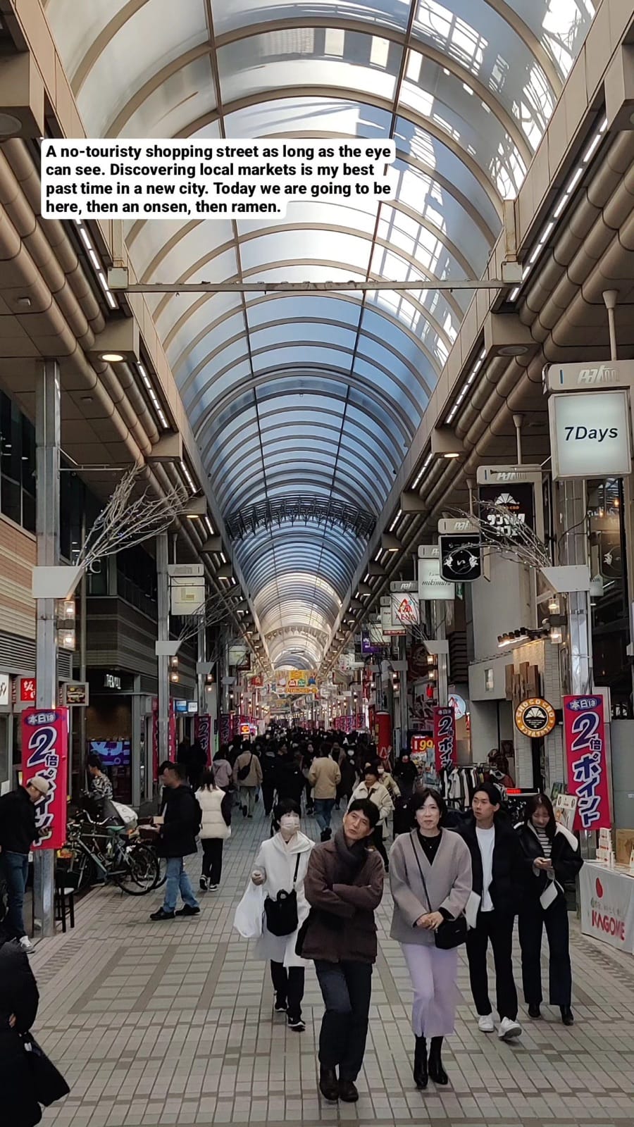 The long glass-roofed Musashi-Koyama Palm shopping arcade in Tokyo with daytime shoppers