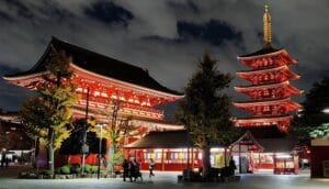 Senso-ji temple's Hozomon gate and five-story pagoda illuminated red at night in Asakusa, Tokyo