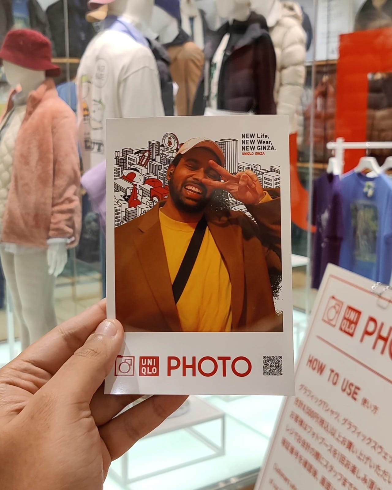 A souvenir UNIQLO PHOTO print from the Ginza flagship store showing the author flashing a peace sign
