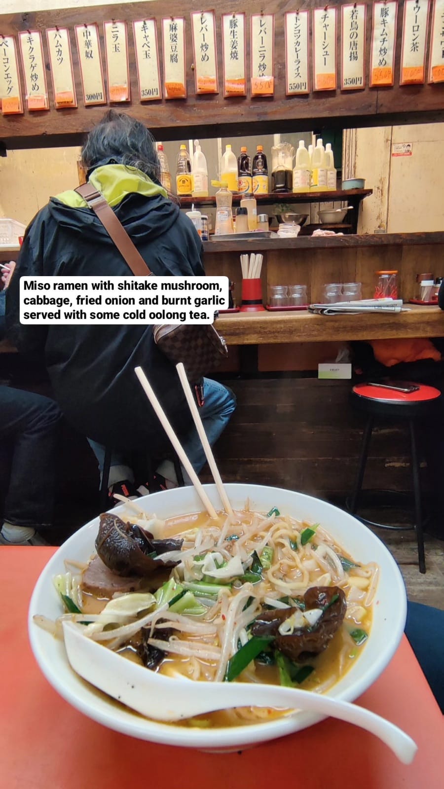 A vegetarian miso ramen bowl with mushrooms, cabbage and burnt garlic at a tiny Tokyo ramen counter