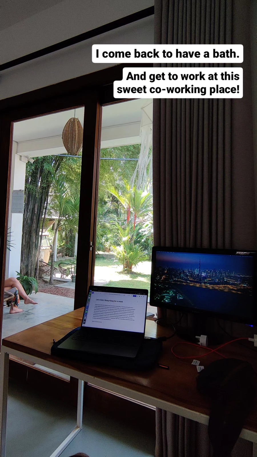 The co-working desk at CLICS Coliving in Hiriketiya with a second monitor and sliding doors onto the garden