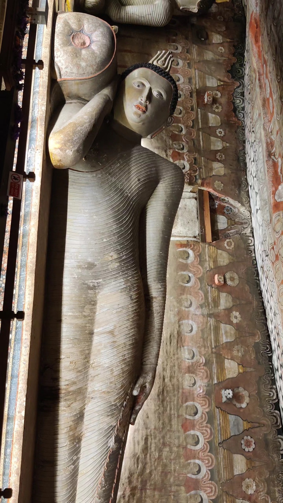 The reclining Buddha carved from the rock inside the Dambulla cave temple