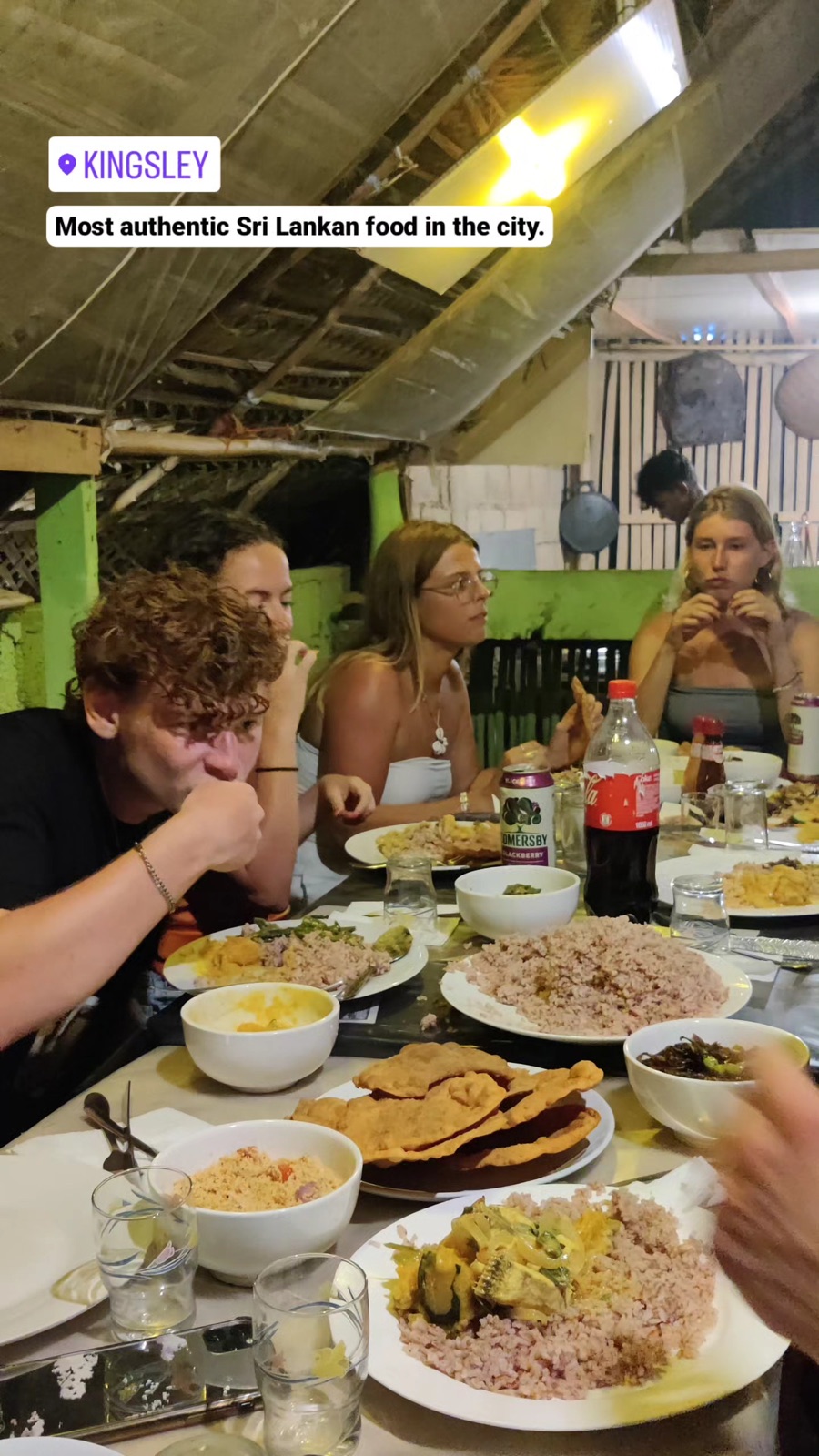Backpackers digging into rice and curry at Kingsley's in Hiriketiya