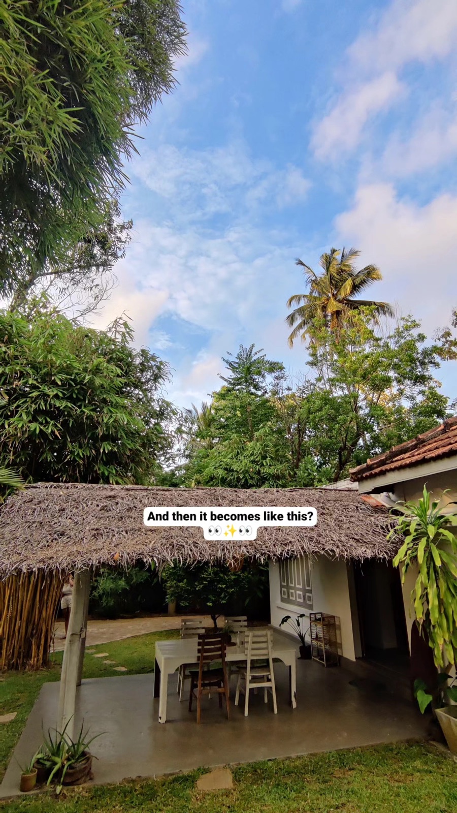 A thatched roof pavilion and empty table under a big sky in the afternoon