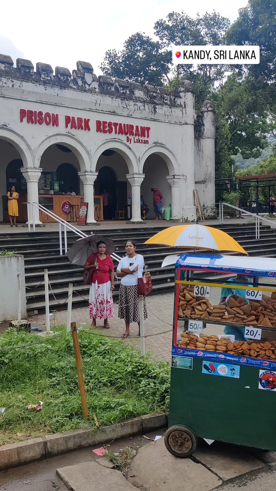 Snack cart outside Prison Park Restaurant in Kandy on a rainy day