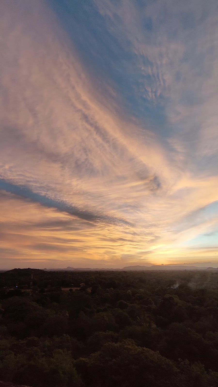 Streaked golden hour sky over the Sigiriya jungle